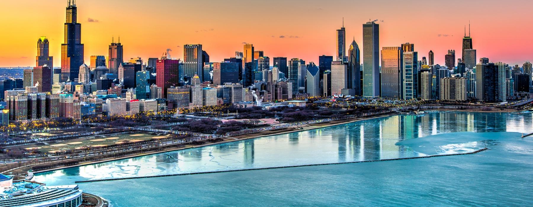a city skyline with a body of water in front of it